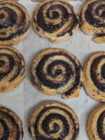 This picture shows multiple poppy seed swirls on a baking tray