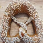 One Original Bavarian Bretzel Sesame Seed Topping on a wooden table