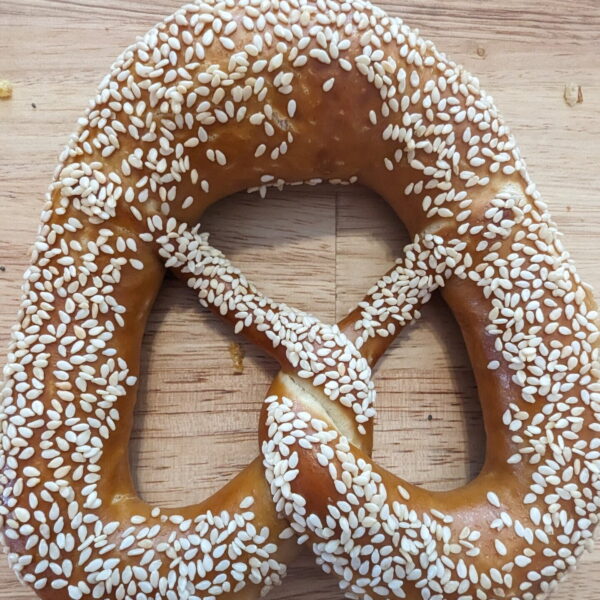 One Original Bavarian Bretzel Sesame Seed Topping on a wooden table
