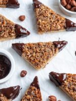 Buttery Nussecken packed with caramelized nuts and dipped in chocolate—Germany’s tastiest triangle