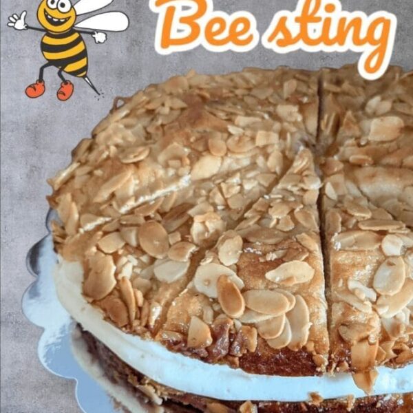 Delicious Bee Sting (Bienenstich) cake with soft dough, honey-caramelized almonds, and a rich vanilla pastry cream filling, topped with a golden, sweet almond glaze