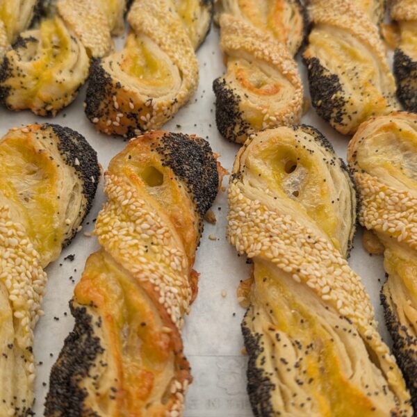 Buttery cheese twist pastry—flaky layers with Emmentaler cheese and a crunchy topping of sesame and poppy seeds.