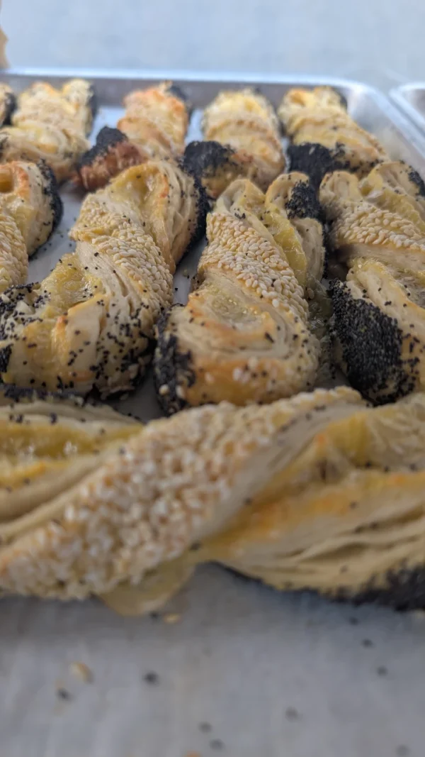 Buttery Cheese Twist Pastry—Flaky Layers With Emmentaler Cheese And A Crunchy Topping Of Sesame And Poppy Seeds.