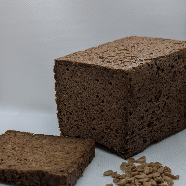 Artisan German pumpernickel bread made with 100 % rye sourdough and sunflower seeds, rich dark crust and dense, hearty texture.